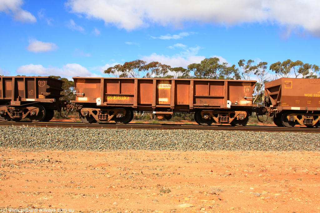 100729 01488
WOB type iron ore waggon WOB 31391 is one of a batch of twenty five built by Comeng WA between 1974 and 1975 and converted from Mt Newman high sided waggons by WAGR Midland Workshops with a capacity of 67 tons with fleet number 316 for Koolyanobbing iron ore operations. This waggon was also converted to a WSM type ballast hopper by re-fitting the cut down top section and having bottom discharge doors fitted, converted back to WOB in 1998, returning empty to Koolyanobbing at Binduli, 29th July 2010.
Keywords: WOB-type;WOB31391;Comeng-WA;WSM-type;Mt-Newman-Mining;