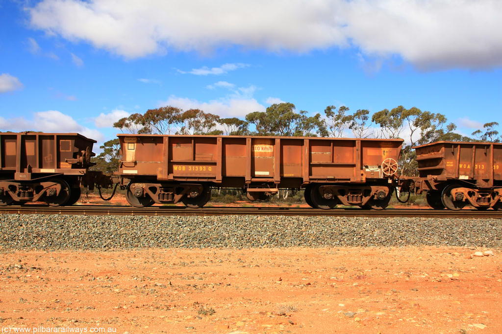 100729 01504
WOB type iron ore waggon WOB 31393 is one of a batch of twenty five built by Comeng WA between 1974 and 1975 and converted from Mt Newman high sided waggons by WAGR Midland Workshops with a capacity of 67 tons with fleet number 318 for Koolyanobbing iron ore operations. This waggon was also converted to a WSM type ballast hopper by re-fitting the cut down top section and having bottom discharge doors fitted, converted back to WOB in 1998, returning empty to Koolyanobbing at Binduli, 29th July 2010.
Keywords: WOB-type;WOB31393;Comeng-WA;WSM-type;Mt-Newman-Mining;