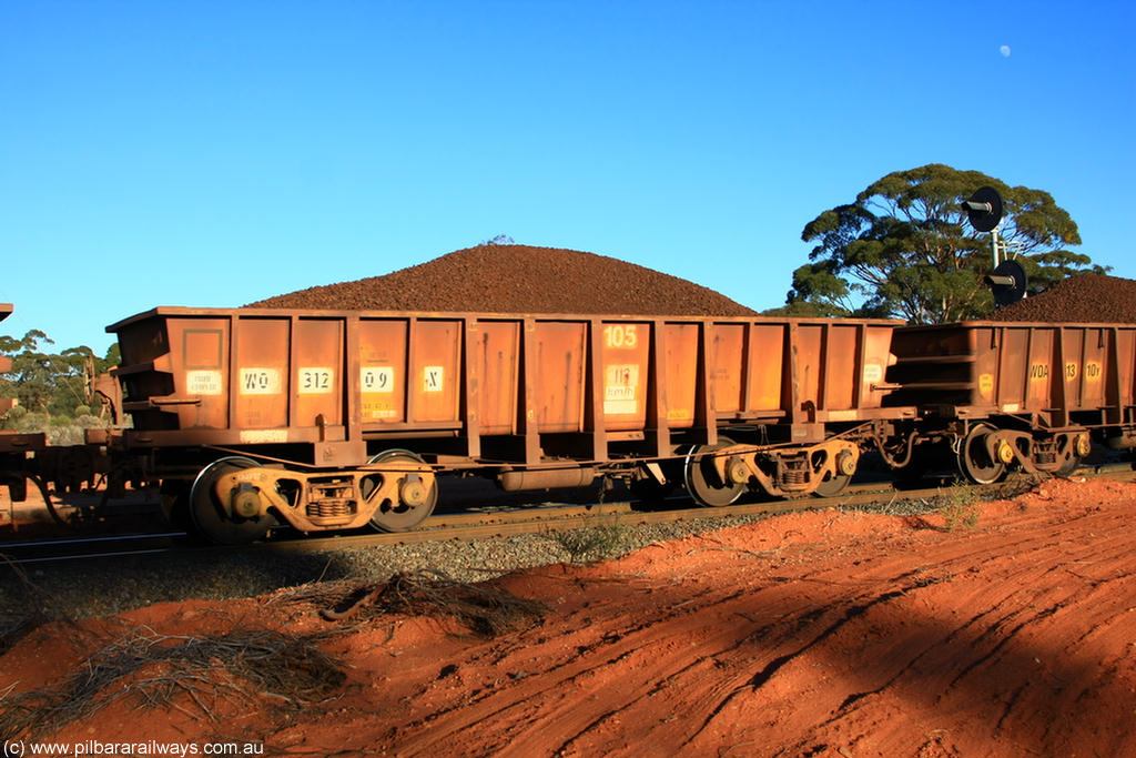 100731 02350
WO type iron ore waggon WO 31209 is leader of a batch of sixty two built by Goninan WA between April and August 2000 with serial number 950086-001 and fleet number 105 for Koolyanobbing iron ore operations, and is a Goninan built replacement WO type waggon with a build date of 05/2000, this replaces the original WAGR built WO type waggon with a WOD type with square features opposed to the curved ones as on the original WO, on loaded train 6413 at Binduli Triangle, 31st July 2010.
Keywords: WO-type;WO31209;Goninan-WA;950086-001;