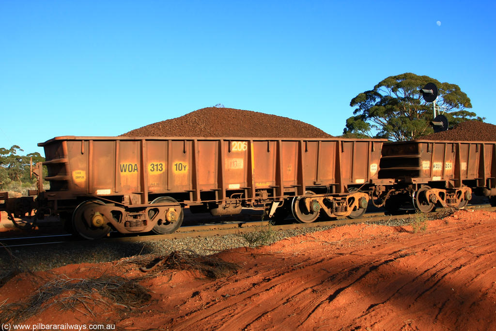 100731 02351
WOA type iron ore waggon WOA 31310 is one of a batch of thirty nine built by WAGR Midland Workshops between 1970 and 1971 with fleet number 206 for Koolyanobbing iron ore operations, with a 75 ton and 1018 ft³ capacity, on loaded train 6413 at Binduli Triangle, 31st July 2010.
Keywords: WOA-type;WOA31310;WAGR-Midland-WS;