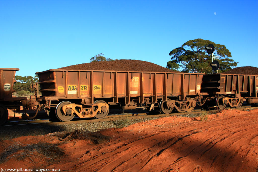 100731 02360
WOA type iron ore waggon WOA 31335 is one of a batch of thirty nine built by WAGR Midland Workshops between 1970 and 1971 with fleet number 215 for Koolyanobbing iron ore operations, with a 75 ton and 1018 ft³ capacity, on loaded train 6413 at Binduli Triangle, 31st July 2010.
Keywords: WOA-type;WOA31335;WAGR-Midland-WS;