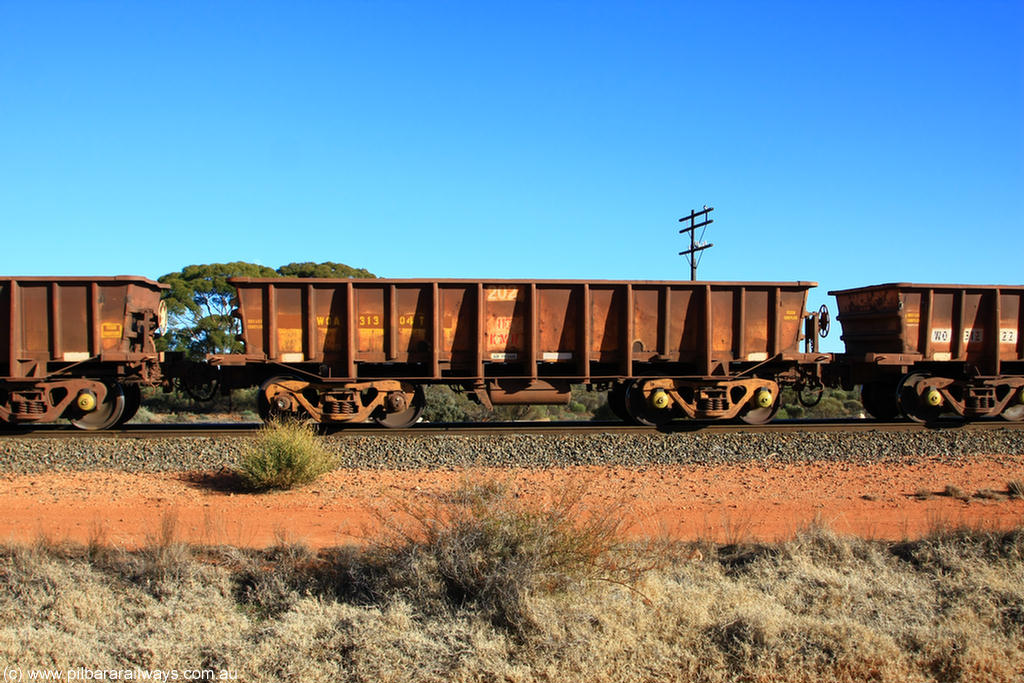 100731 02424
WOA type iron ore waggon WOA 31304 is one of a batch of thirty nine built by WAGR Midland Workshops between 1970 and 1971 with fleet number 202 for Koolyanobbing iron ore operations, with a 75 ton and 1018 ft³ capacity, on empty train 6418 at Binduli Triangle, 31st July 2010.
Keywords: WOA-type;WOA31304;WAGR-Midland-WS;