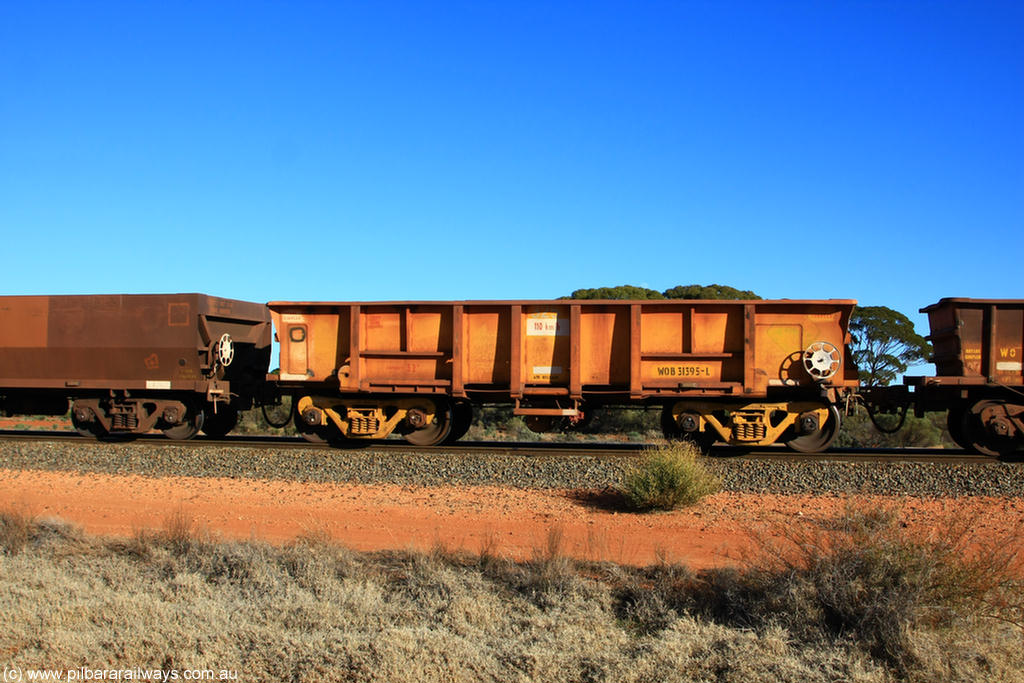 100731 02426
WOB type iron ore waggon WOB 31395 is one of a batch of twenty five built by Comeng WA between 1974 and 1975 and converted from Mt Newman high sided waggons by WAGR Midland Workshops with a capacity of 67 tons with fleet number 325 for Koolyanobbing iron ore operations. This waggon was also converted to a WSM type ballast hopper by re-fitting the cut down top section and having bottom discharge doors fitted, converted back to WOB in 1997, on empty train 6418 at Binduli Triangle, 31st July 2010.
Keywords: WOB-type;WOB31395;Comeng-WA;WSM-type;Mt-Newman-Mining;