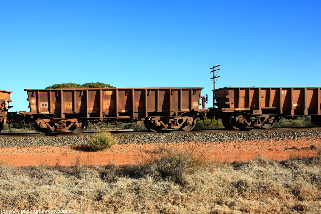 100731 02535
WO type iron ore waggon WO 31220 is one of a batch of eighty six built by WAGR Midland Workshops between 1967 and March 1968 with fleet number 115 for Koolyanobbing iron ore operations, with a 75 ton and 1018 ft³ capacity, on empty train 6418 at Binduli Triangle, 31st July 2010.
Keywords: WO-type;WO31220;WAGR-Midland-WS;