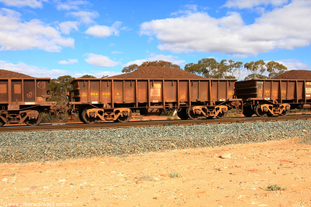 100731 02890
WOA type iron ore waggon WOA 31315 is one of a batch of thirty nine built by WAGR Midland Workshops between 1970 and 1971 with fleet number 208 for Koolyanobbing iron ore operations, with a 75 ton and 1018 ft³ capacity, on loaded train 7415 at Binduli Triangle, 31st July 2010.
Keywords: WOA-type;WOA31315;WAGR-Midland-WS;