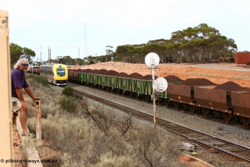 060116 2683
AOPY and WOE iron ore waggons loaded with lump ore depart West Kalgoorlie for Esperance as the Prospector awaits entry to continue to Kalgoorlie, while Pope Searle takes in the action, West Kalgoorlie 16th January 2006.
Keywords: AOPY-type;WOE-type;