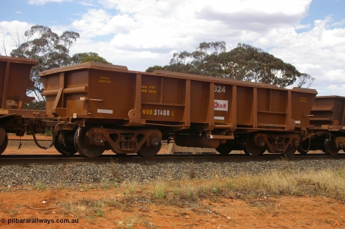 PD 12415
Binduli, WOB type iron ore waggon WOB 31400 is one of a batch of twenty five built by Comeng WA between 1974 and 1975 and converted from Mt Newman high sided waggons by WAGR Midland Workshops with a capacity of 67 tons with fleet number 324 for Koolyanobbing iron ore operations, but purchased by WAGR. This waggon is one of the 15 converted to WSM type ballast hoppers by re-fitting the removed top section of the body and fitting bottom discharge doors, converted back to WOB in 1998, and shows signs of heavy re-sheeting and full repainting.
Keywords: Peter-D-Image;WOB-type;WOB31400;Comeng-WA;WSM-type;Mt-Newman-Mining;