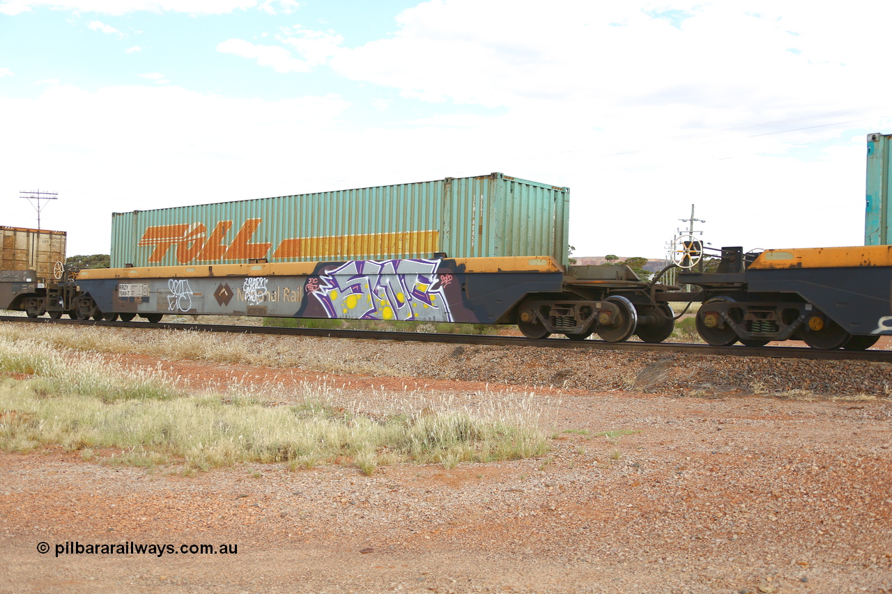 210407 9890
Parkeston, 2MP5 intermodal train, RRZY 7049 platform 1 of 5-pack well waggon set. Originally was an RQZY type, a five unit bar coupled well container waggon built as one of a batch of thirty two by Goninan NSW for National Rail in 1995/96. Recoded to RRZY when repaired. Loaded with a Toll 48' MEG1 type container TCML 48459. National Rail logo still visible.
Keywords: RRZY-type;RRZY7049;Goninan-NSW;RQZY-type;