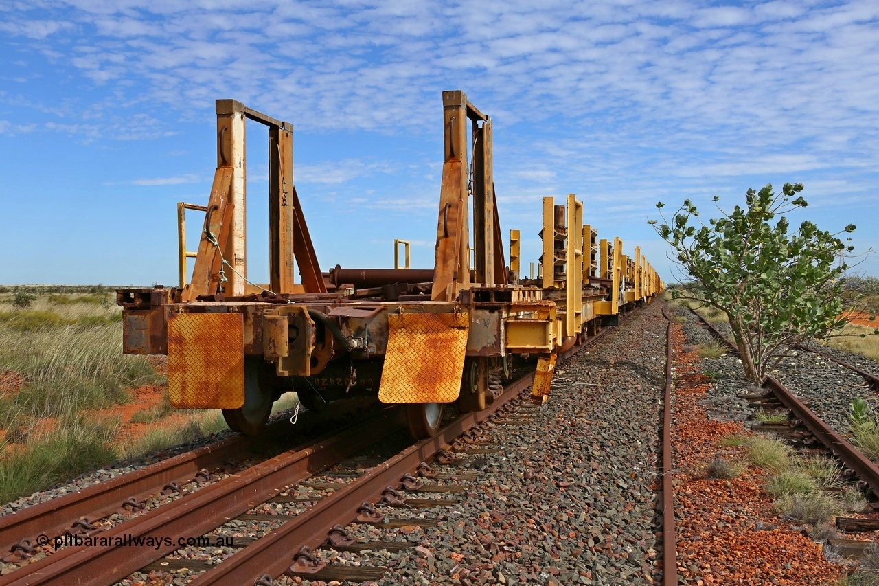 180614 1281
Allen Siding, at the 45 km looking west, the original rail or steel train is stowed on the mainline, looking from the rear lead off waggon 6203, built by Comeng WA in January 1977. The chute arrangement for the discharging and recovery of rail is visible. 14th June 2018. [url=https://goo.gl/maps/UE2dRkZvdBr]GeoData[/url].
