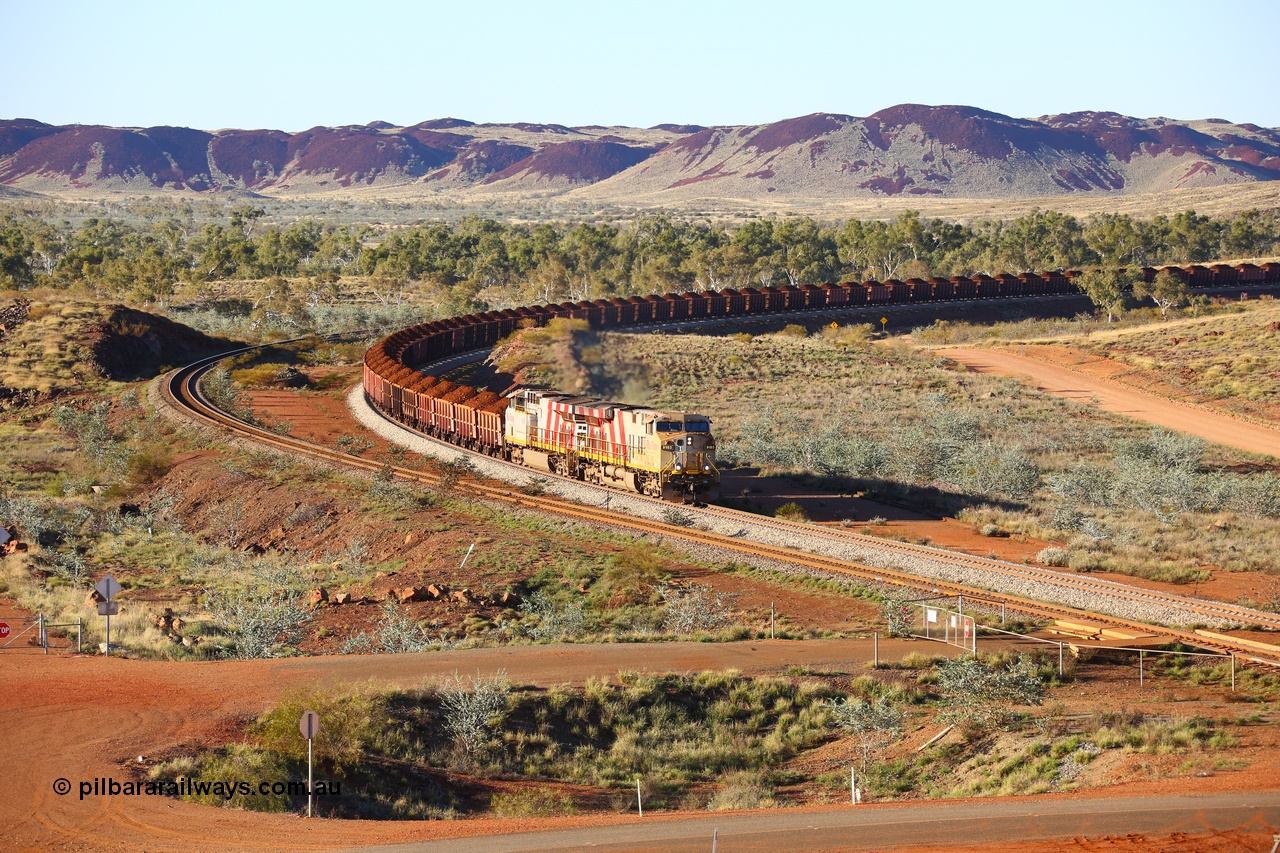 180616 1628
Harding Siding, a loaded train from Mesa A behind double Rio Tinto loco 9103 with serial 61941 a GE Erie built GE model ES44ACi from the 1st order in Rio Tinto Stripes livery and 9108 serial 62539 with 167 'J' type ore waggons around the curve at the 38.5 km. 16th June 2018. [url=https://goo.gl/maps/JKiinSDiquy]GeoData[/url]
Toad Montgomery image.
Keywords: 9103;61941;GE;ES44ACi;Rio-Tinto-Stripes;