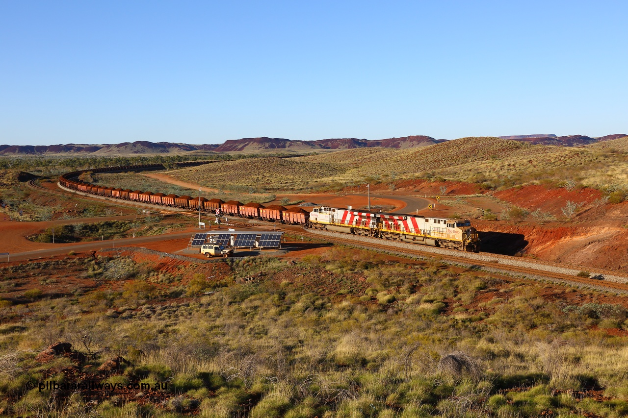 180616 1635
Harding Siding, a loaded train from Mesa A behind double Rio Tinto loco 9103 with serial 61941 a GE Erie built GE model ES44ACi from the 1st order in Rio Tinto Stripes livery and 9108 serial 62539 with 167 'J' type ore waggons rounds the curve at the 38.5 km grade crossing. 16th June 2018. [url=https://goo.gl/maps/JKiinSDiquy]GeoData[/url]
Toad Montgomery image.
Keywords: 9103;GE;ES44ACi;61941;Rio-Tinto-Stripes;