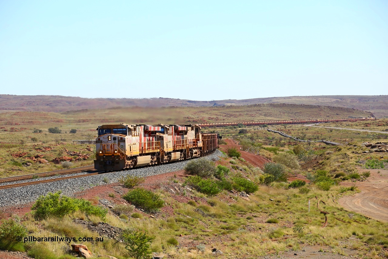 180616 1810
Emu Siding, an empty train from Cape Lambert powers upgrade away from Emu Siding up the 1.6 percent grade behind Rio Tinto loco 8149 with serial 58730 a GE Erie built GE model ES44DCi from the 3rd order in Rio Tinto Stripes livery and 8193 with Dash 9-44CW unit 7089 with a consist of S and C type waggons. 16th June 2018. [url=https://goo.gl/maps/M5Nc32gSiLy]GeoData[/url].
Keywords: 8149;58730;GE;ES44DCi;Rio-Tinto-Stripes;