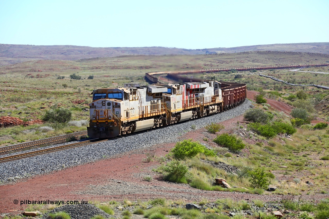 180616 1830
Emu Siding, an empty train from Cape Lambert powers upgrade away from Emu Siding up the 1.6 percent grade behind triple General Electric ES44DCi units Rio Tinto loco 8112 with serial 59104 a GE Erie built GE model ES44DCi from the 2nd order in Rio Tinto livery and 8162 in the Rio Tinto stripes and 8116 in Rio Tinto silver with a consist of S and C type waggons. 16th June 2018. [url=https://goo.gl/maps/M5Nc32gSiLy]GeoData[/url].
Keywords: 8112;59104;GE;ES44DCi;Rio-Tinto;