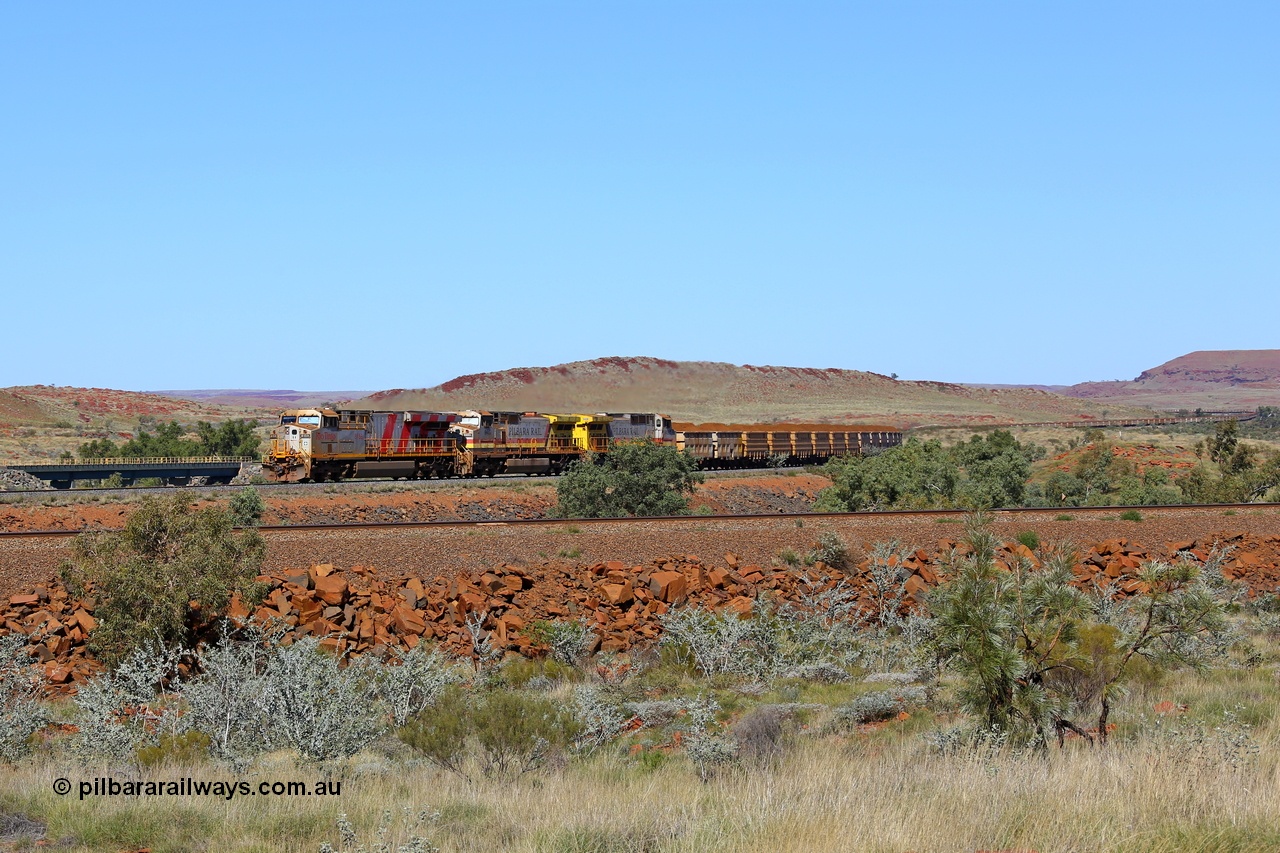 180616 1881
Western Creek, the train on the middle track lead by Rio Tinto loco 8153 with serial 58813 a GE Erie built GE model ES44DCi from the 4th order in Rio Tinto Stripes livery leading two Dash 9-44CW units in the Pilbara Rail livery with ROBE ownership markings with a loaded bound for Cape Lambert and running on the Western Creek West mainline at the 74 km with the bridges over Western Creek and the train stretching back up into Emu Siding. The track in the foreground is the mainline to Dampier with the line in the background the Western Creek East mainline to Cape Lambert. 16th June 2018. [url=https://goo.gl/maps/rH9HZ4CCSS82]GeoData[/url].
Keywords: 8153;58813;GE;ES44DCi;Rio-Tinto-Stripes;