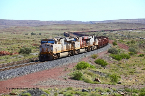 180616 1830
Emu Siding, an empty train from Cape Lambert powers upgrade away from Emu Siding up the 1.6 percent grade behind triple General Electric ES44DCi units Rio Tinto loco 8112 with serial 59104 a GE Erie built GE model ES44DCi from the 2nd order in Rio Tinto livery and 8162 in the Rio Tinto stripes and 8116 in Rio Tinto silver with a consist of S and C type waggons. 16th June 2018. [url=https://goo.gl/maps/M5Nc32gSiLy]GeoData[/url].
Keywords: 8112;GE;ES44DCi;59104;Rio-Tinto;
