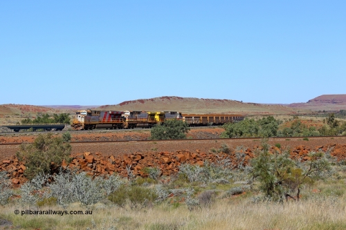 180616 1881
Western Creek, the train on the middle track lead by Rio Tinto loco 8153 with serial 58813 a GE Erie built GE model ES44DCi from the 4th order in Rio Tinto Stripes livery leading two Dash 9-44CW units in the Pilbara Rail livery with ROBE ownership markings with a loaded bound for Cape Lambert and running on the Western Creek West mainline at the 74 km with the bridges over Western Creek and the train stretching back up into Emu Siding. The track in the foreground is the mainline to Dampier with the line in the background the Western Creek East mainline to Cape Lambert. 16th June 2018. [url=https://goo.gl/maps/rH9HZ4CCSS82]GeoData[/url].
Keywords: 8153;GE;ES44DCi;58813;Rio-Tinto-Stripes;