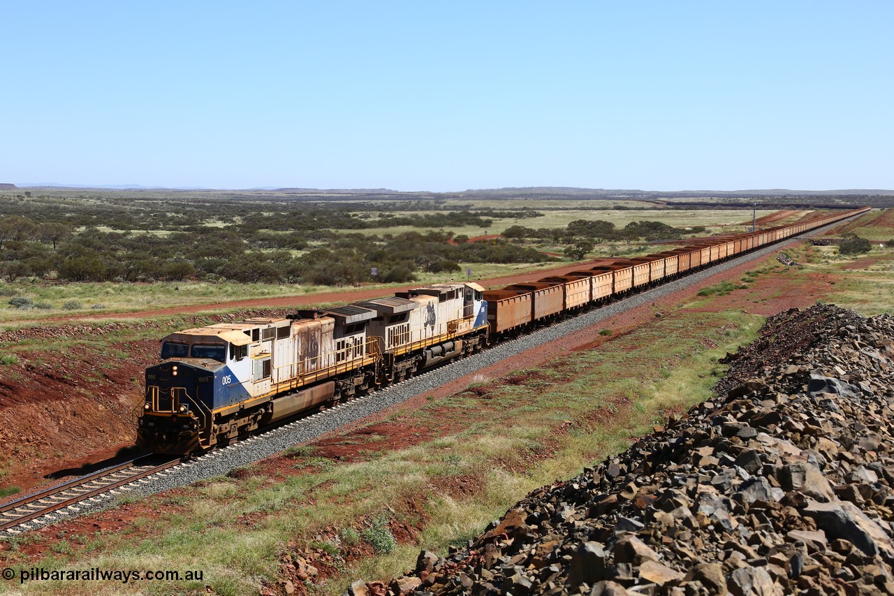 150505 7963
FMG Solomon Line, a pair of General Electric Dash 9-44CW locomotives 005 serial 58182 and 006 serial 58183 struggle upgrade with a loaded train at the 227 km bound for Port Hedland, the bank engines assisting in the rear can just be seen. Geodata: [url=https://goo.gl/maps/NjHo38Gc7kE2] -22.0189283 118.5861050 [/url].
Keywords: FMG-005;GE;Dash-9-44CW;58182;FMG-006;58183;
