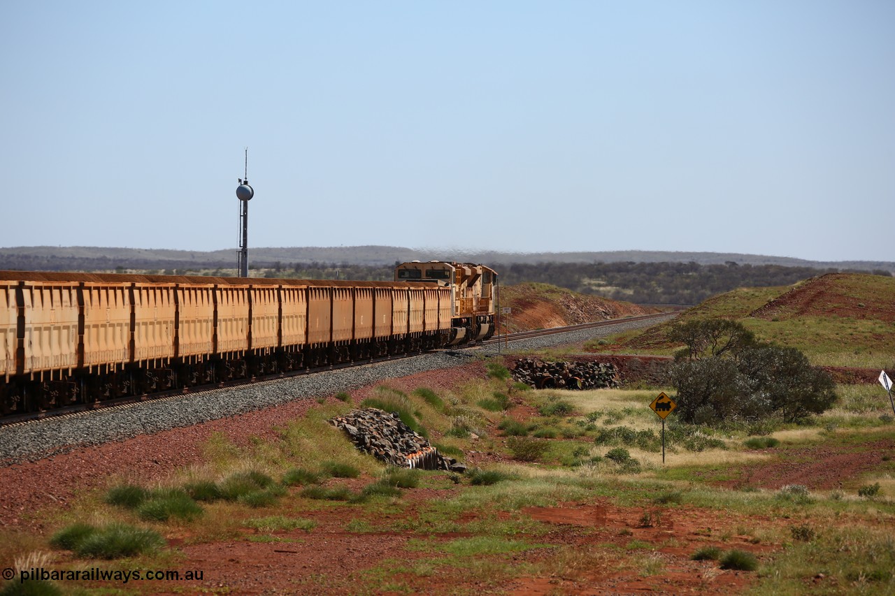 150505 7982
FMG Solomon Line, bank engines Progress Rail EMD SD70ACe/LCi unit 716 serial 20118693-008 and EMD SD90MAC unit 901 serial 976833-1, this unit has been repowered with an 16-710G3 prime mover, cross the 227.5 km grade crossing as they shove the loaded train upgrade at an increasing speed as the front of the train has topped the grade. Geodata: [url=https://goo.gl/maps/gSzXJkmY3ux] -22.0187117 118.5850933 [/url].
Keywords: FMG-716;Progress-Rail-Muncie-USA;EMD;SD70ACe/LCi;FMG-901;SD90MAC-H2;