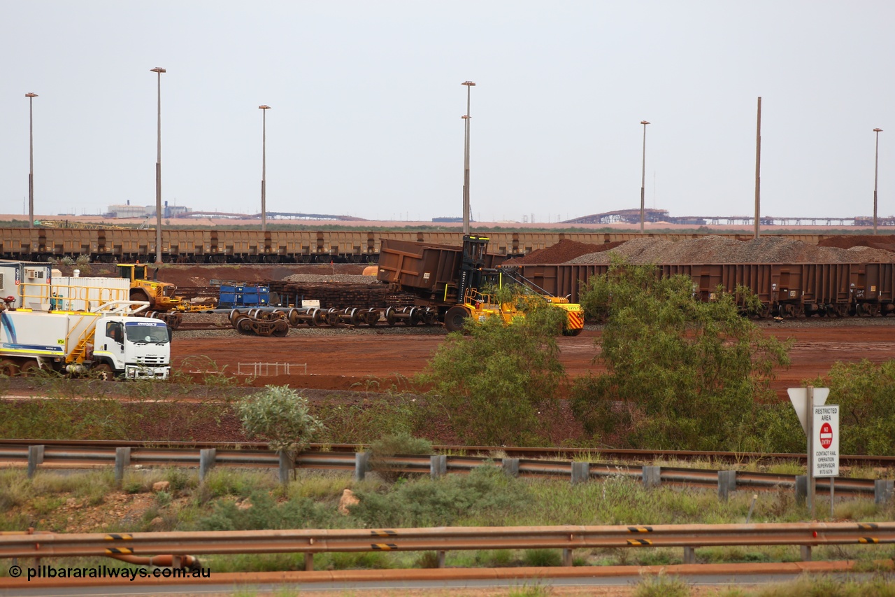 150523 8232
Nelson Point Yard, I Area, waggon scrapping by Sims Metal, a fork lift carries waggon no. 3340, one of 350 waggons built in Romania of which only about 60 made it into service, the rest rusting away in a caged embargo area out on the Broome Road until they were scrapped some years ago. There is a connection with these waggons and Lang Hancock and his former mine McCamey's Monster, now known as Jimblebar.
Keywords: Arad-Romania;BHP-ore-waggon;