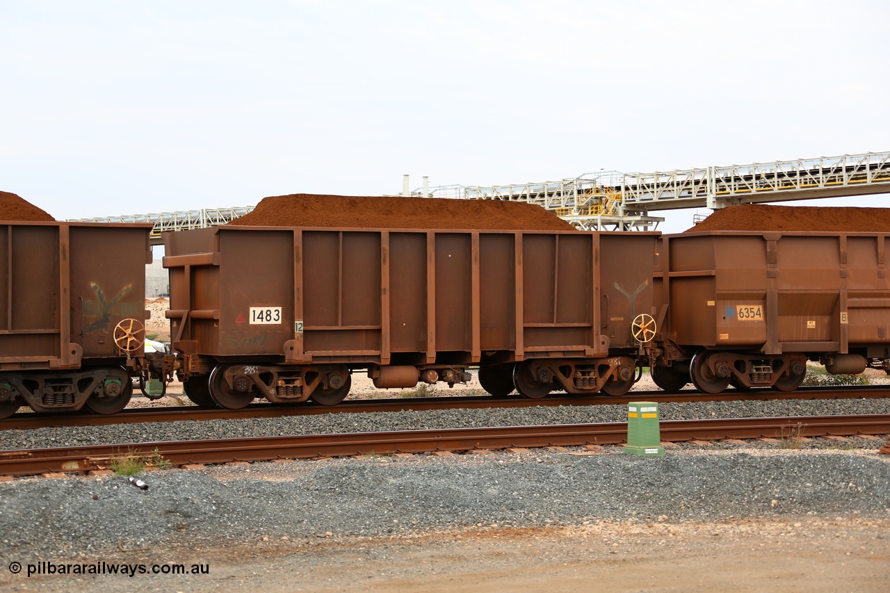 150523 8280
Finucane Island, loaded with Yandi Fines Comeng built original style ore waggon number 1483 dates from 1974. It has had the end sills filled in as a capacity improvement and show signs of having been re-sheeted and repaired, it is also riding on light weight 38 tonne bogies. Geodata: [url=https://goo.gl/maps/HUaomivQnAw] -20.3363567 118.5497550 [/url].
Keywords: Comeng-WA;BHP-ore-waggon;