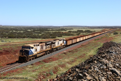 150505 7963
FMG Solomon Line, a pair of General Electric Dash 9-44CW locomotives 005 serial 58182 and 006 serial 58183 struggle upgrade with a loaded train at the 227 km bound for Port Hedland, the bank engines assisting in the rear can just be seen. Geodata: [url=https://goo.gl/maps/NjHo38Gc7kE2] -22.0189283 118.5861050 [/url].
Keywords: FMG-005;GE;Dash-9-44CW;58182;FMG-006;58183;