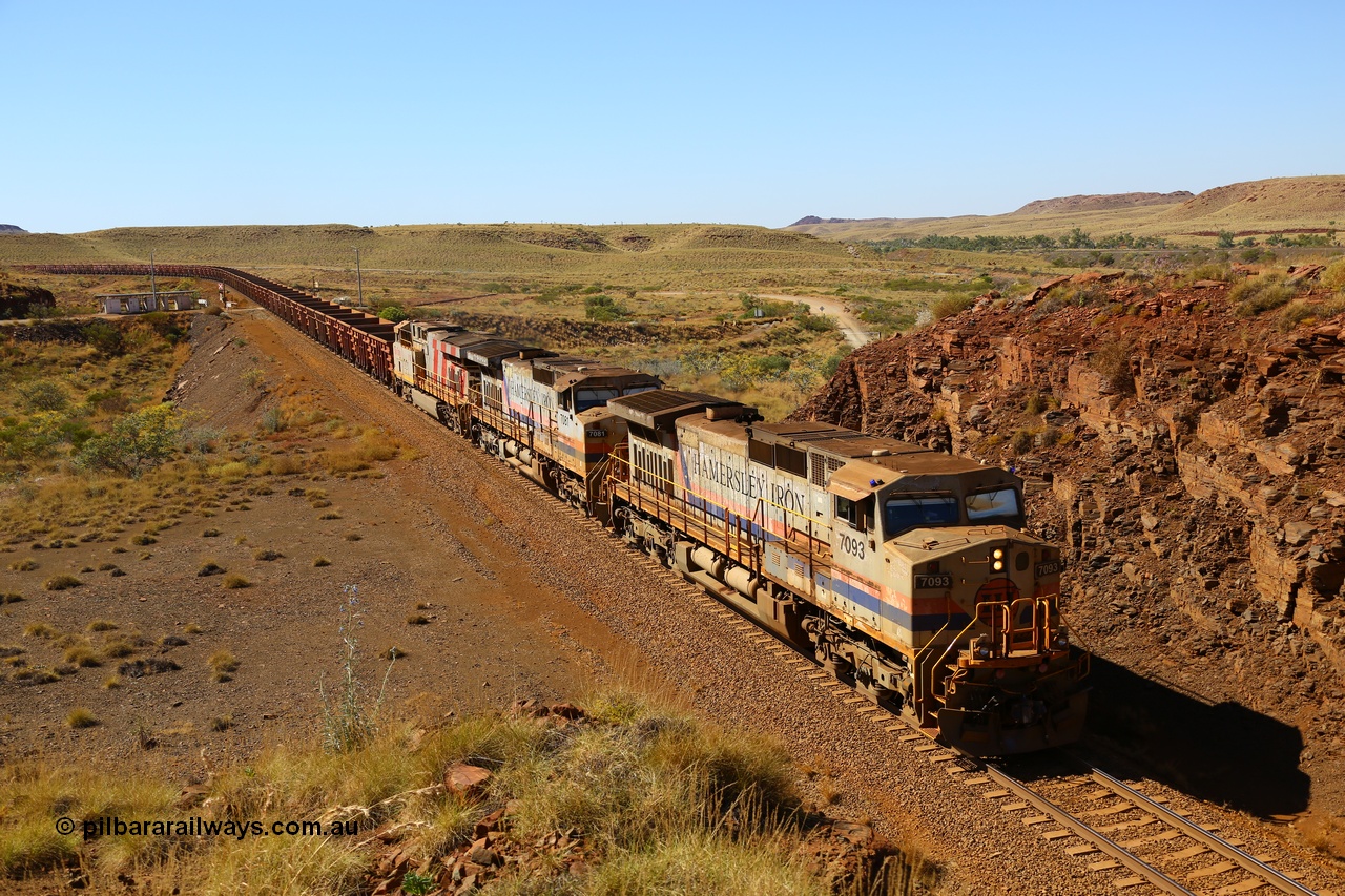 170728 09833
Western Creek - Emu area, an empty train from Dampier climbs the grade on approach to the Robe River line overpass behind original liveried General Electric built Dash 9-44CW units 7093 serial 47772 and 7081 with third unit a stablemate ES44DCi 8189, the blue lights on the cab of 7093 being illuminated as the train is operating in AutoHaul™ mode. 28th July 2017. [url=https://goo.gl/maps/vvUWXEgppNM2]GeoData[/url].
Keywords: 7093;47772;GE;Dash-9-44CW;