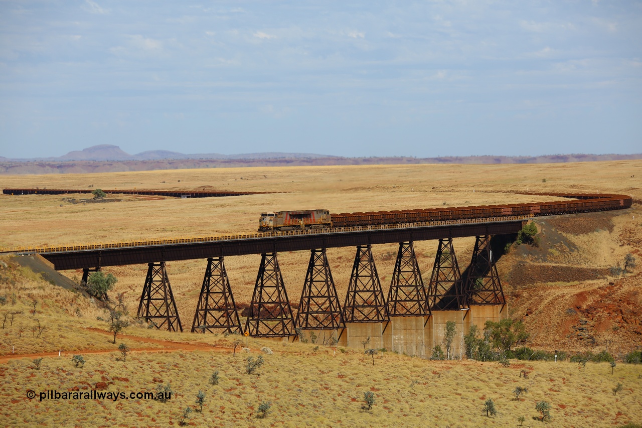 170729 0163
Fortescue River Bridge on the Robe River line at the 115.8 km, a loaded Deepdale train heading for Cape Lambert behind the standard motive power for this line, double General Electric built ES44ACi units, 9114 serial 62545 and sister unit 9101 serial 61939 run over the largest rail bridge in the Pilbara. 29th July 2017. [url=https://goo.gl/maps/urXsiFNXfiz]GeoData[/url].
Keywords: 9114;62545;GE;ES44ACi;