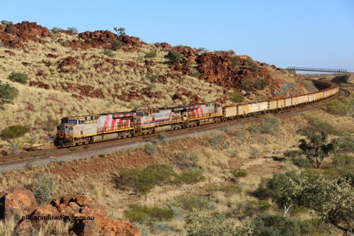 170728 09716
38 km on approach to Harding Siding an empty train rounds the curve under the Water Corp pipe bridge lead by Rio Tinto stripe liveried unit 8147 serial 58728 an General Electric built ES44DCi unit with a sister unit 8149 sandwiching 7065 a Dash 9-44CW unit. July 28, 2017. [url=https://goo.gl/maps/hbJFTzVVYc22]GeoData[/url].
Keywords: 8147;GE;ES44DCi;58728;