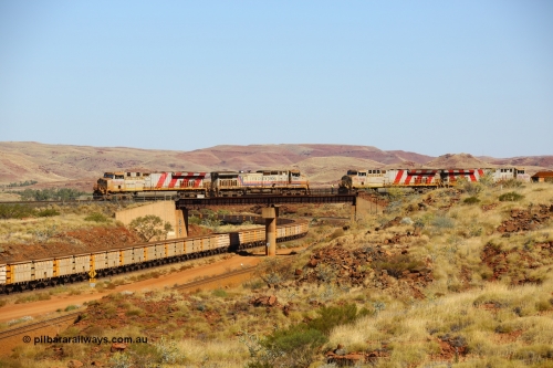 170728 09819
Western Creek, a disabled train from Mesa A on the right behind ES44ACi unit 9103 has relief locos 7082 serial 47761 a General Electric built Dash 9-44CW and a General Electric built ES44DCi unit 8137 ease up to couple onto 9103s disabled train. This image shows all these models of locomotive on the Rio Tinto mainline roster as an empty train climbs upgrade under the bridge. July 28, 2017. [url=https://goo.gl/maps/n4HzBo2eGrz]GeoData[/url].
Keywords: 7082;GE;Dash-9-44CW;47761;
