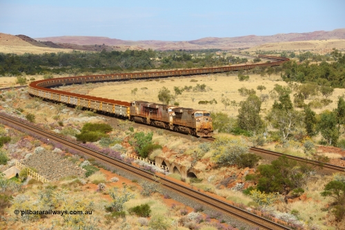 170729 0119
Green Pool, as they cross the #6 bridge on the original Robe River line with their train snaking all the way back to Western Creek, General Electric built ES44DCi unit 8114 serial 59106 in original silver livery and operating in AutoHaul™ with later sister units 8120 and 8148 with a loaded train from Yandicoogina. July 29, 2017. [url=https://goo.gl/maps/hJHqGCy1HKk]GeoData[/url].
Keywords: 8114;GE;ES44DCi;59106;