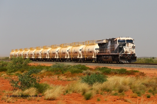 170915 0705
Great Northern Highway 18.2 km grade crossing, empty Roy Hill fuel train powers along bound for Tad Yard with General Electric built ES44ACi unit RHA 1019 serial 64300 leading eleven of Roy Hill's twelve tank waggons. 15th September 2017. [url=https://goo.gl/maps/DR61N4rDVZy]View map here[/url].
Keywords: RHA-class;RHA1019;GE;ES44ACi;64300;