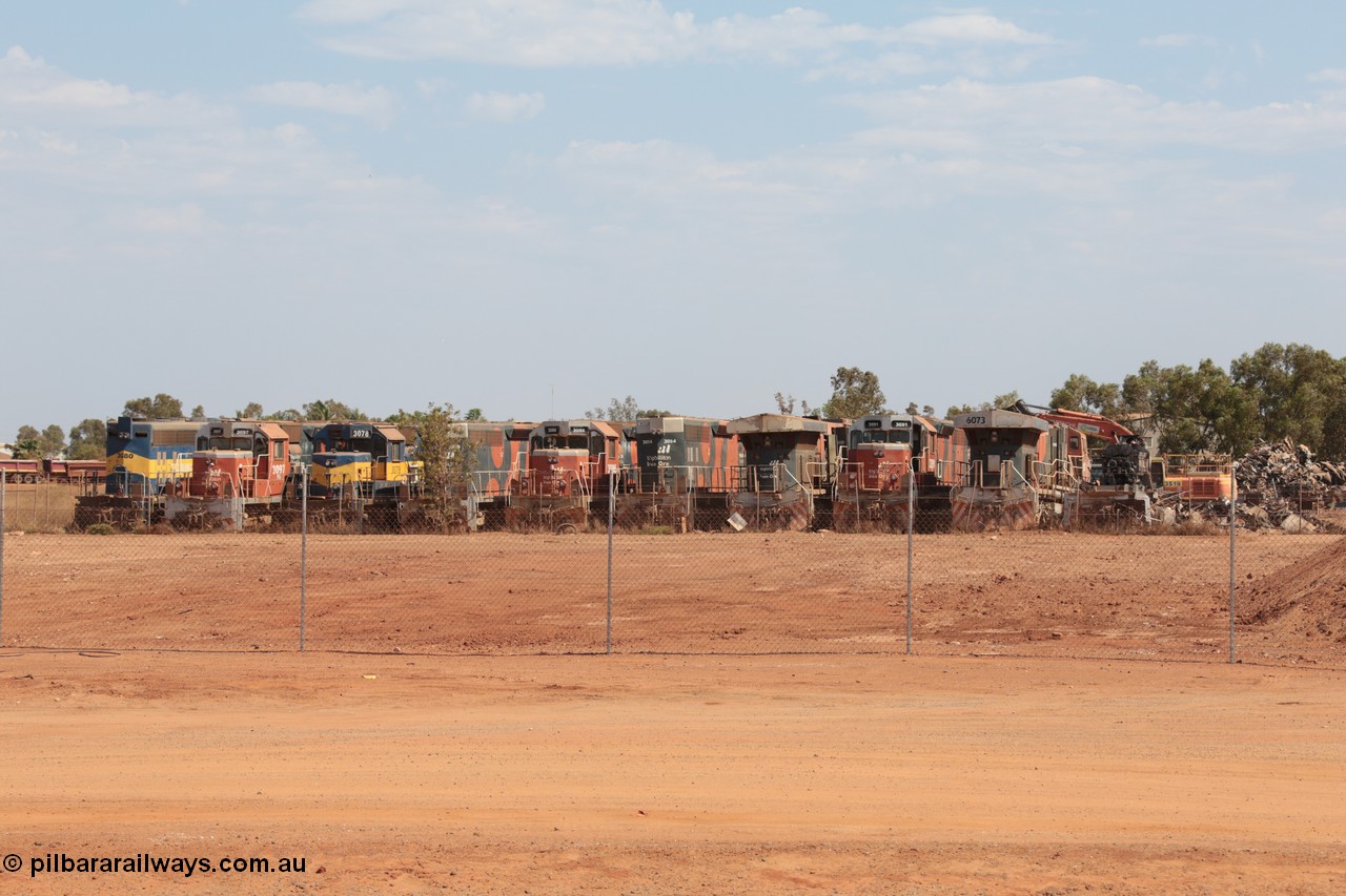 141025 5818
Wedgefield, WA, view from the new bypass road looking into the rear of Sell and Parker's metal recycling yard with former BHP Billiton Iron Ore EMD SD40, SD40R and GE AC6000 model units lined up awaiting their fate, from left, EMD SD40 3080, SD40R 3097, SD40 3078, SD40R 3088, 3086, 3094, AC6000 6075, SD40R 3091, AC6000 6073 and remains of another SD40R.
Keywords: SD40;SD40R;EMD;AC6000;GE;