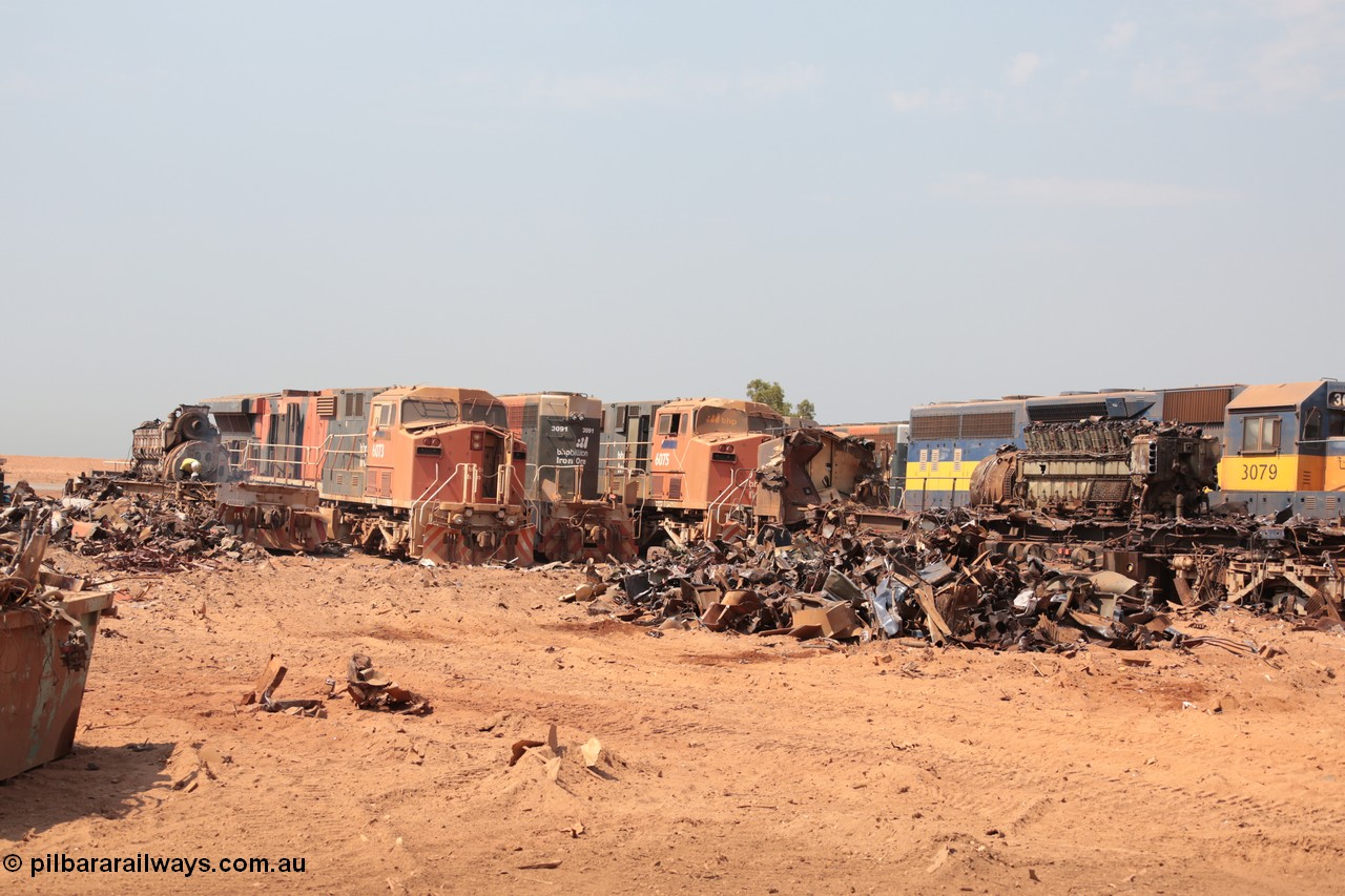 141027 5825
Wedgefield, view out the back of Sell and Parker's metal recycling yard shows a sorry sight. From left is the frame of an SD40R and prime mover, AC6000 6073, SD40R 3091, AC6000 6075 and SD40 3079. Beside 3079 is the remains of AC6000 unit 6071 having been reduced from one of the most powerful locomotives to work in Australia to a munched up tangled mass of metal, the EVO motor is still in the frame.
Keywords: S+P;6073;6075;3079;GE;AC6000;EMD;SD40R;51065;51067;31542/7861-52;