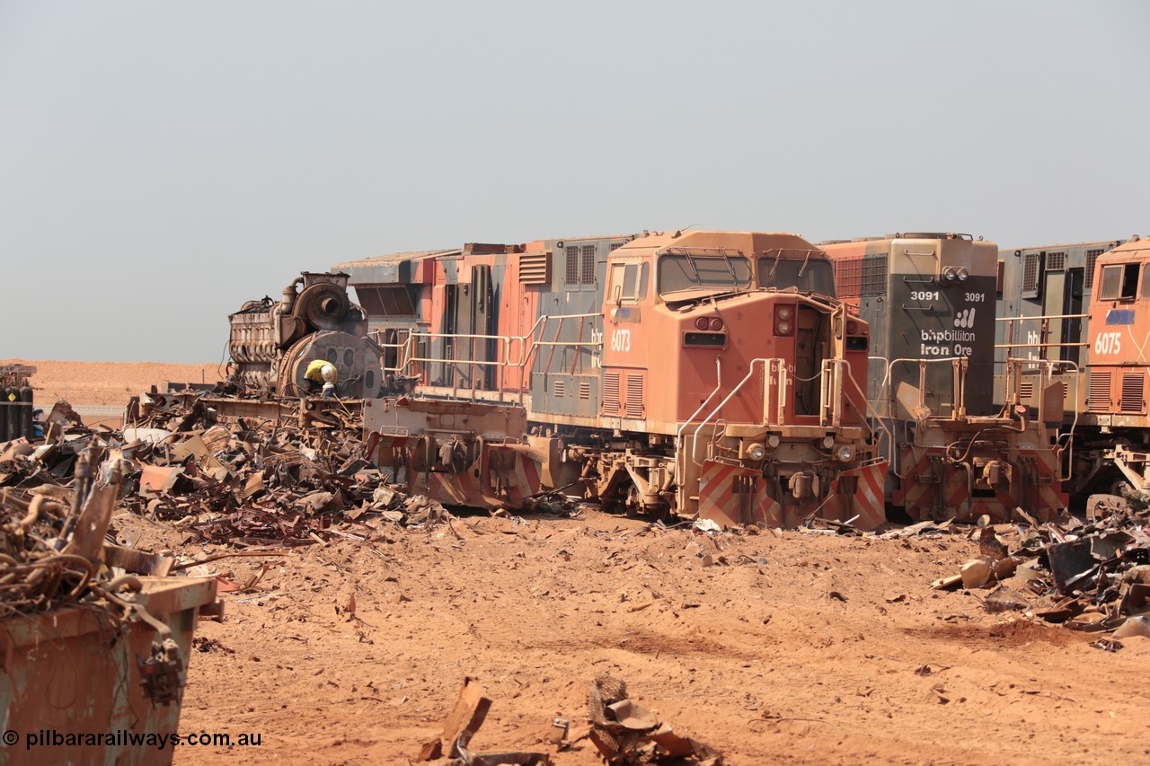 141027 5827
Wedgefield, Sell and Parker's metal recycling yard, with what remains of an SD40R and prime mover having the frame cut into three pieces, as the once mighty GE AC6000 6073 and SD40R 3091 wait their turn to ne reduced to scrap.
Keywords: S+P;6073;GE;AC6000;51065;EMD;SD40R;3091;31496/7861-6;