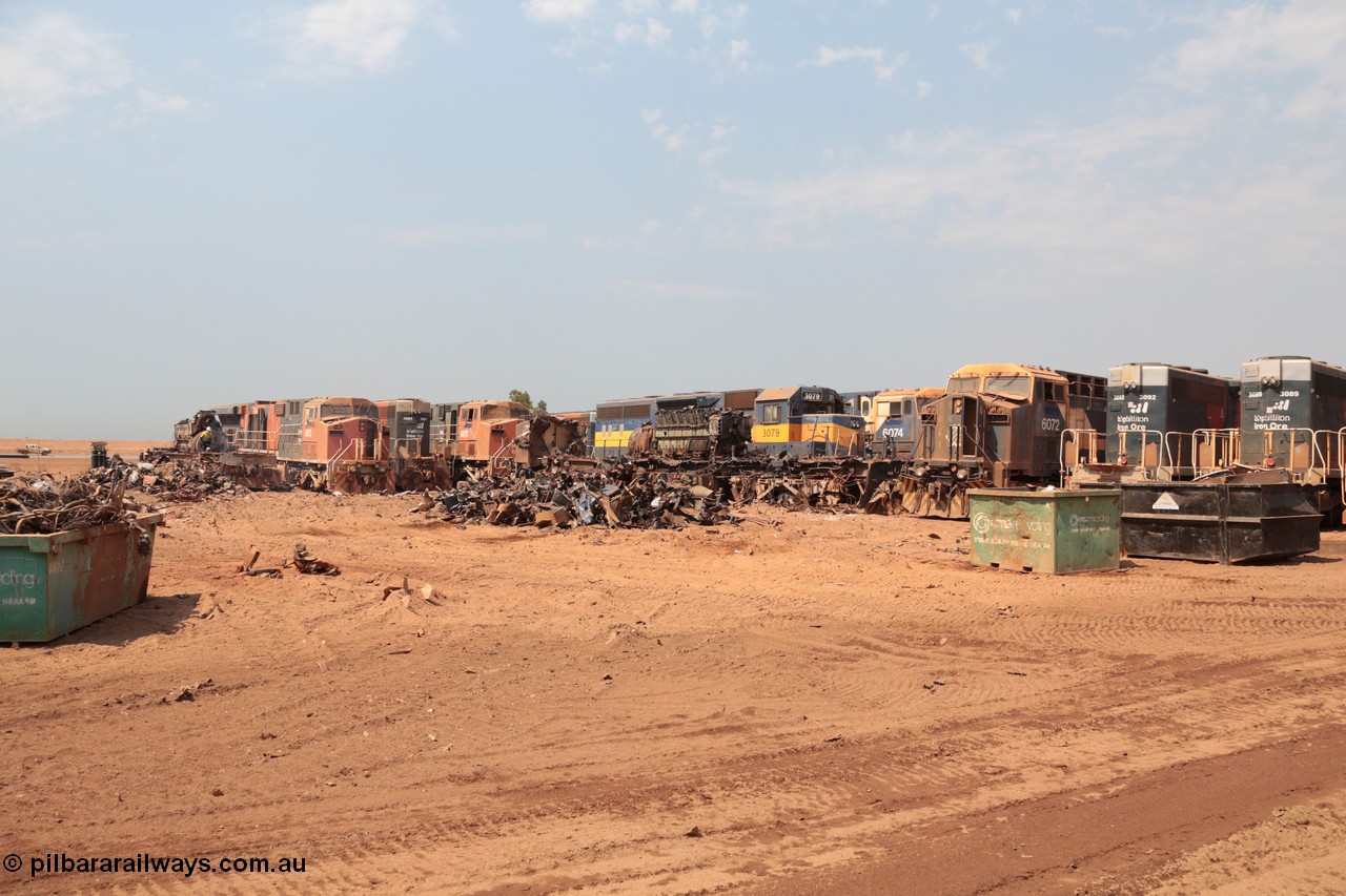 141027 5828
Wedgefield, Sell and Parker's metal recycling yard, overview of the carnage. Units visible awaiting the shears and gas are, GE AC6000 6073, EMD SD40R 3091, AC6000 6075, EMD SD40 3079, AC6000 6074 and 6072 and SD40R 3092 and 3089.
