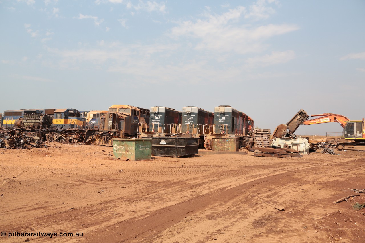 141027 5829
Wedgefield, Sell and Parker's metal recycling yard, overview of the carnage. Units visible awaiting the shears and gas are, EMD SD40 3079, which is behind the frame of GE AC6000 6071, AC6000 6074 and 6072 and SD40R 3092, 3089 and 3095 with a frame part from a former SD40R and the excavator with the hydraulic shears.
