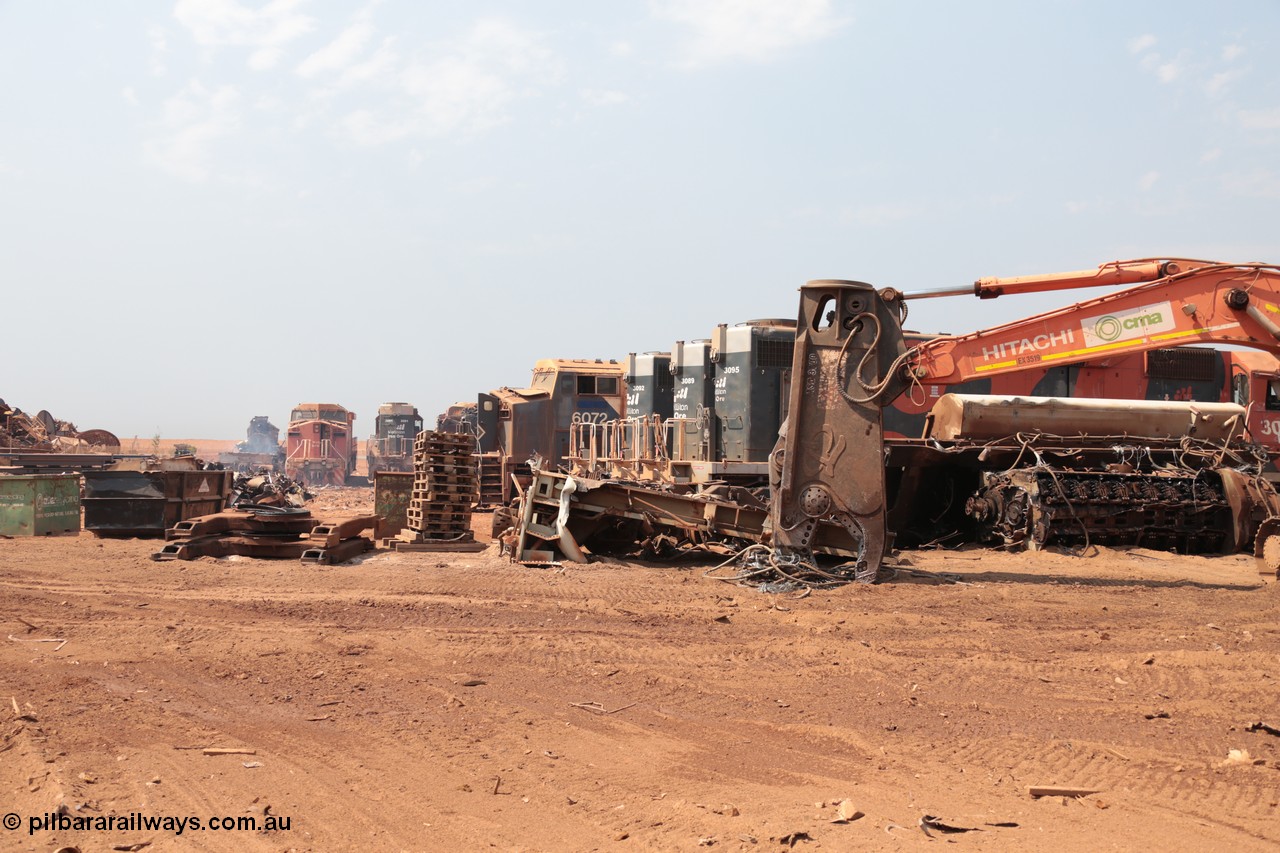 141027 5831
Wedgefield, Sell and Parker's metal recycling yard, overview of the carnage. Units visible awaiting the shears and gas are, GE AC6000 6073, EMD SD40R 3091, AC6000 6072, SD40R 3092, 3089 and 3095 flanked by the remains of an SD40R with the hydraulic shears and EMD 645 engine on its side.
