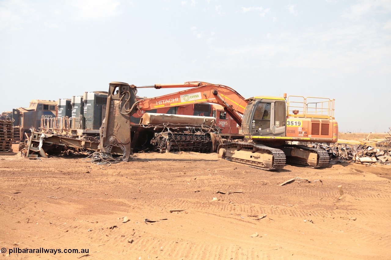 141027 5833
Wedgefield, Sell and Parker's metal recycling yard, view of Hitachi ZAXIS 350 LCH excavator fitted with the huge hydraulically operated shears that are making a meal of former EMD SD40 and GE AC6000 locomotives. Behind it lays the remains of an EMD SD40R unit which has been reduced to a few frame part with the EMD 645 engine laying over. Behind it sister units 3095, 3089 and 3092 along with an GE AC6000 6072 wait for a similar fate.
