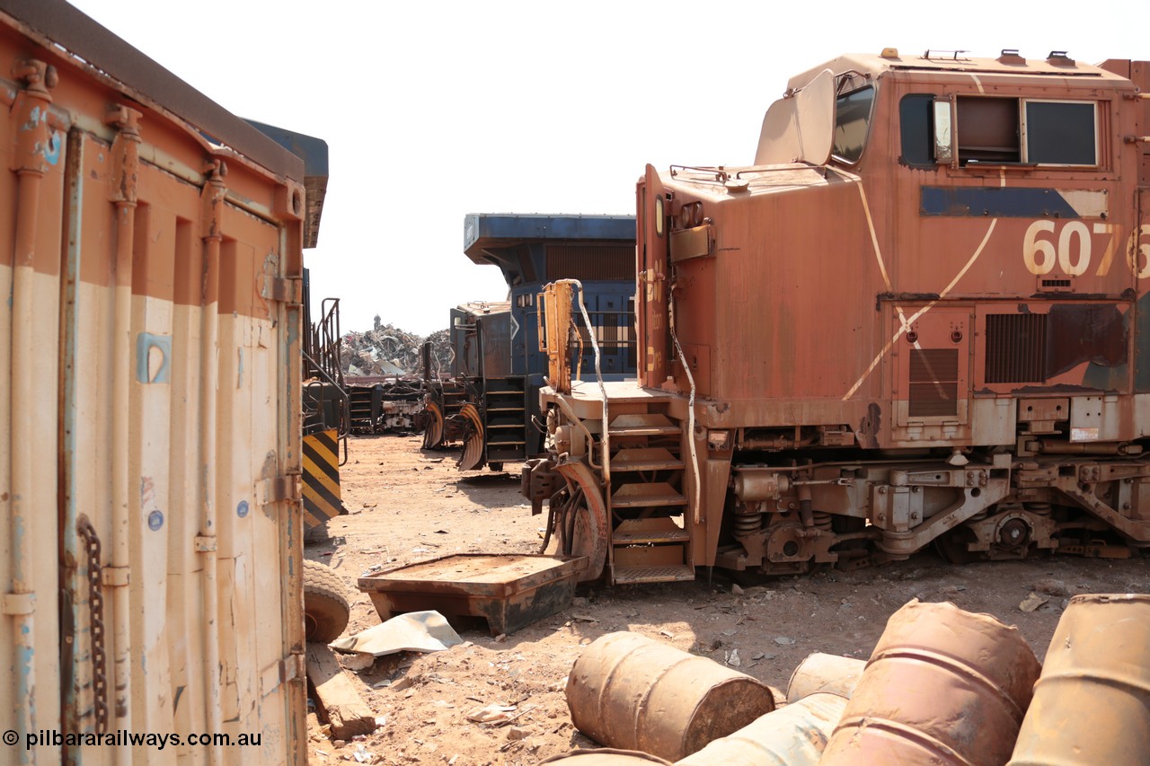 141027 5849
Wedgefield, Sell and Parker's metal recycling yard, General Electric AC6000 units lined up awaiting the chop, 6076 serial 51068, then the rear of 6077 and the nose of 6074.
Keywords: 6076;GE;AC6000;51068;