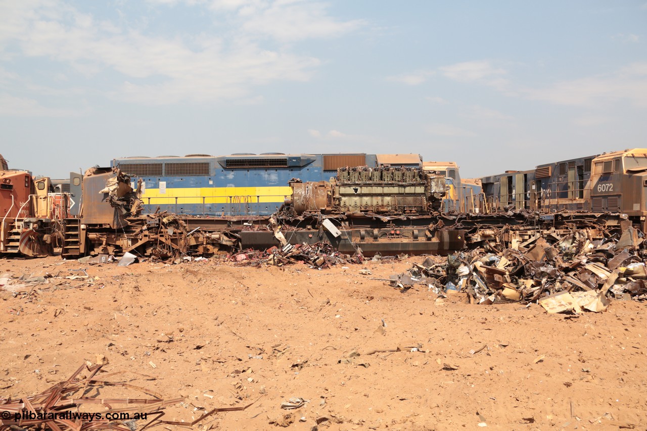 141027 5895
Wedgefield, Sell and Parker's metal recycling yard, General Electric AC6000 unit 6071 serial 51063 is reduced to frame level with only the nose which contains the collision posts and the 6600 hp EVO motor and alternator awaiting the thermal lance.
Keywords: 6071;GE;AC6000;51063;