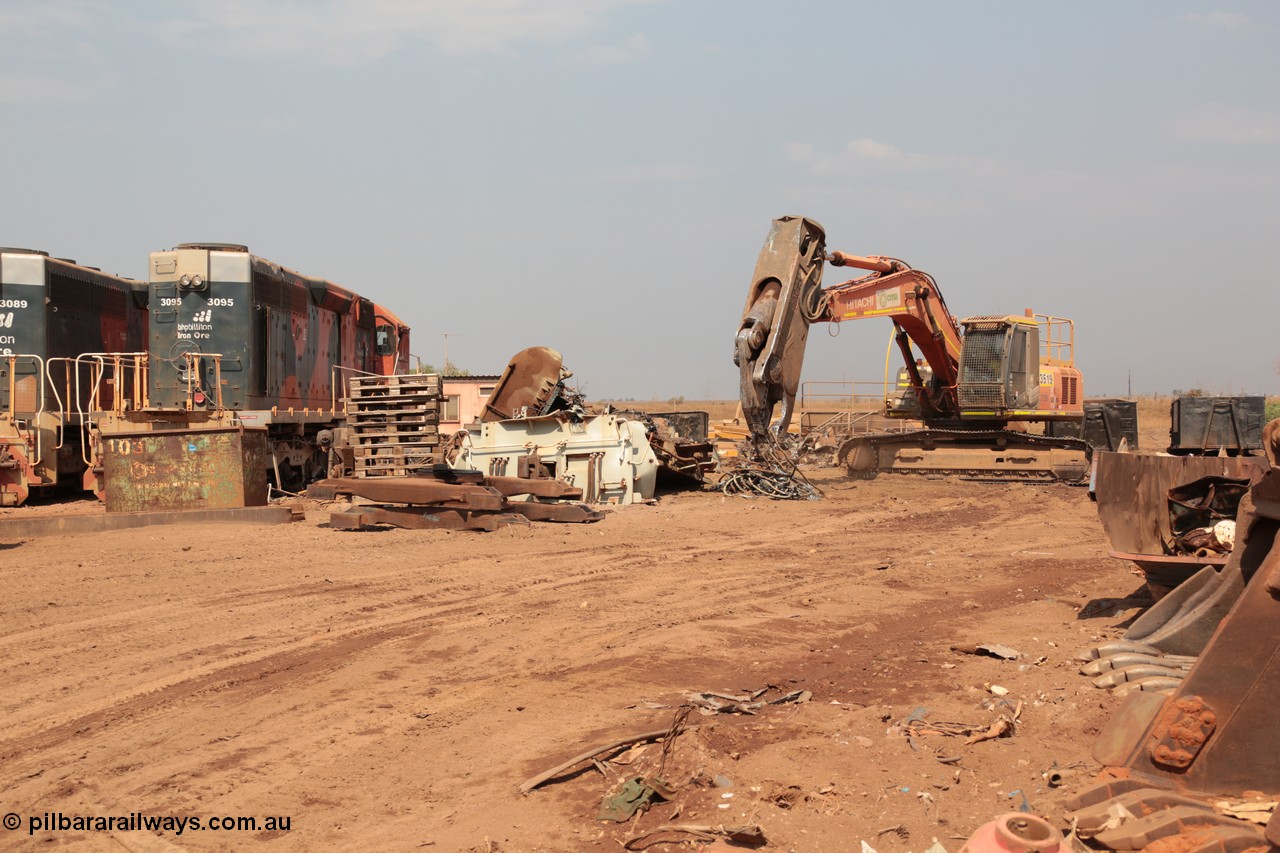 141027 5912
Wedgefield, Sell and Parker's metal recycling yard, view of Hitachi ZAXIS 350 LCH excavator fitted with the huge hydraulically operated shears that are making a meal of former EMD SD40 and GE AC6000 locomotives. Besides it lays the remains of an EMD SD40R unit which has been reduced to a few frame part with the EMD 645 engine laying over, sister units 3095 wait for a similar fate.
