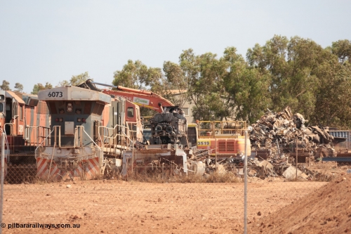 141025 5822
Wedgefield, WA, view from the new bypass road looking into the rear of Sell and Parker's metal recycling yard with former BHP Billiton Iron Ore EMD SD40R and GE AC6000 model units lined up awaiting their fate, from left, EMD SD40R 3091, AC6000 6073 and remains of another SD40R.
Keywords: 6073;GE;AC6000;51065;
