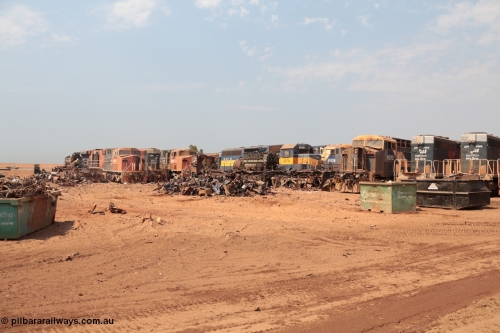 141027 5828
Wedgefield, Sell and Parker's metal recycling yard, overview of the carnage. Units visible awaiting the shears and gas are, GE AC6000 6073, EMD SD40R 3091, AC6000 6075, EMD SD40 3079, AC6000 6074 and 6072 and SD40R 3092 and 3089.
