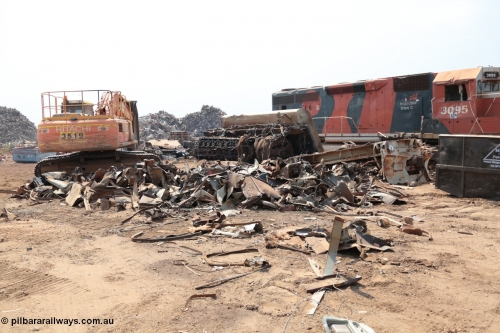 141027 5837
Wedgefield, Sell and Parker's metal recycling yard, view of EMD SD40R unit 3095 serial 33677/7083-7 watching a former sister unit being reduced to bits, a primer mover 645 EMD engine and fuel tank tipped on its side, and the excavator with the hydraulic shears.
Keywords: 3095;EMD;SD40R;33677/7083-7;SD40;SP8485;