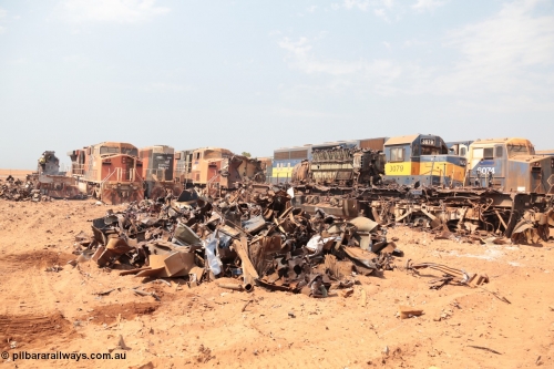 141027 5868
Wedgefield, Sell and Parker's metal recycling yard, an EMD SD40R is getting the thermal lance treatment to cut the frame while other GE AC6000 and EMD SD40R units look on, AC6000 unit 6071 has been reduced to just the frame with the EVO 6600 horsepower engine awaiting the lance as well.
