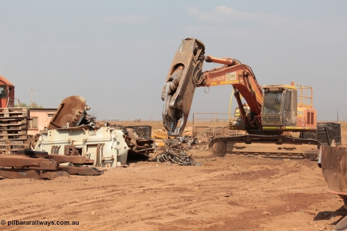 141027 5913
Wedgefield, Sell and Parker's metal recycling yard, view of Hitachi ZAXIS 350 LCH excavator fitted with the huge hydraulically operated shears that are making a meal of former EMD SD40 and GE AC6000 locomotives. Besides it lays the remains of an EMD SD40R unit which has been reduced to a few frame part with the EMD 645 engine laying over.
