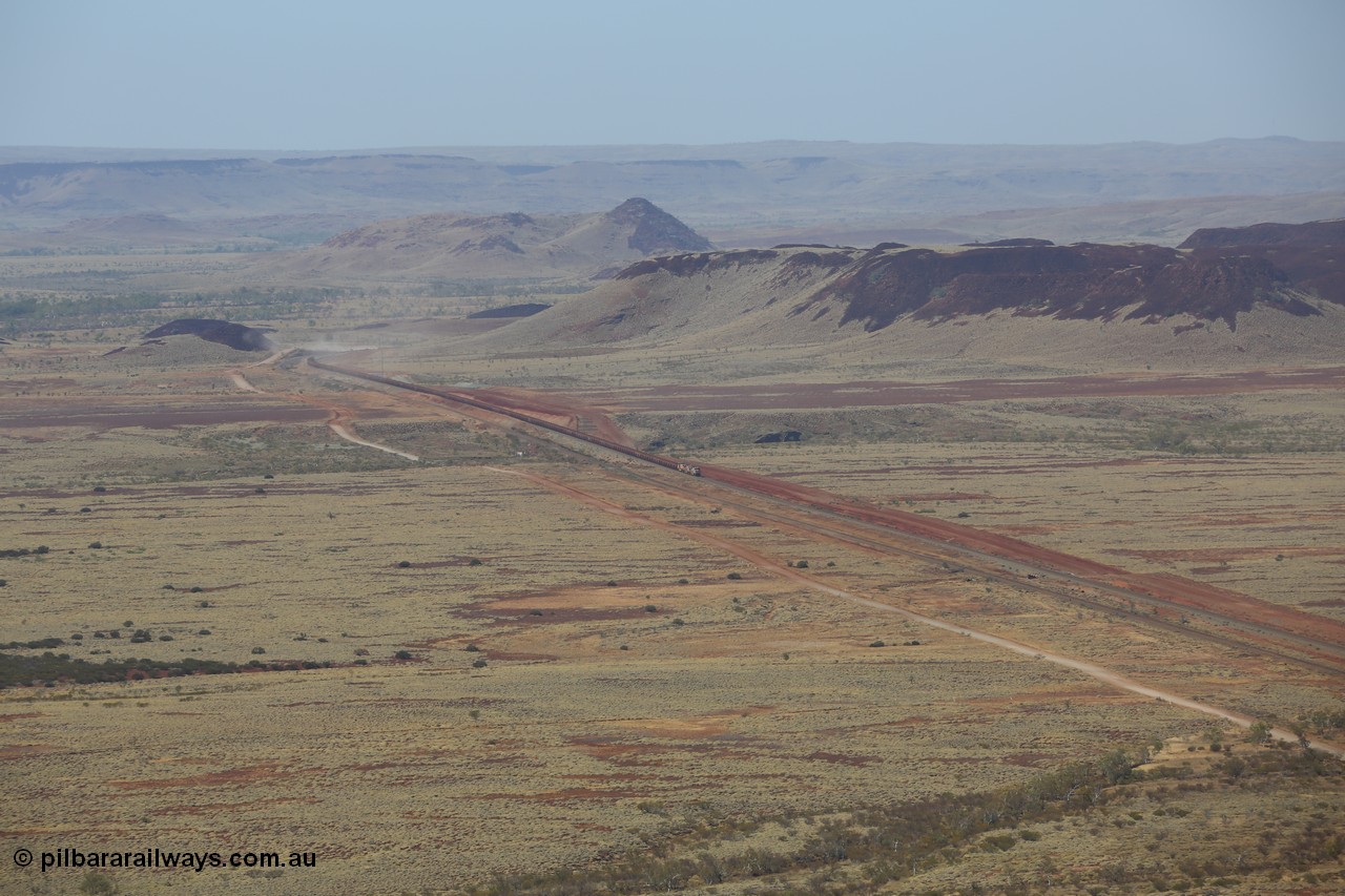 151111 9504
A loaded train behind General Electric ES44DCi units 8113 serial 59105 in the original silver livery and 8145 serial 58726 in the tiger strip Rio livery and Dash 9-44CW 9433 serial 54766 in ROBE Pilbara Iron livery runs along on the West Mainline bound for Cape Lambert viewed from Table Hill.
