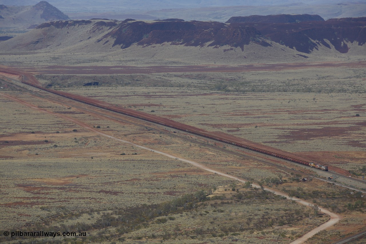 151111 9507
A loaded train behind General Electric ES44DCi units 8113 serial 59105 in the original silver livery and 8145 serial 58726 in the tiger strip Rio livery and Dash 9-44CW 9433 serial 54766 in ROBE Pilbara Iron livery runs along on the West Mainline bound for Cape Lambert viewed from Table Hill.
Keywords: 8113;GE;ES44DCi;59105;