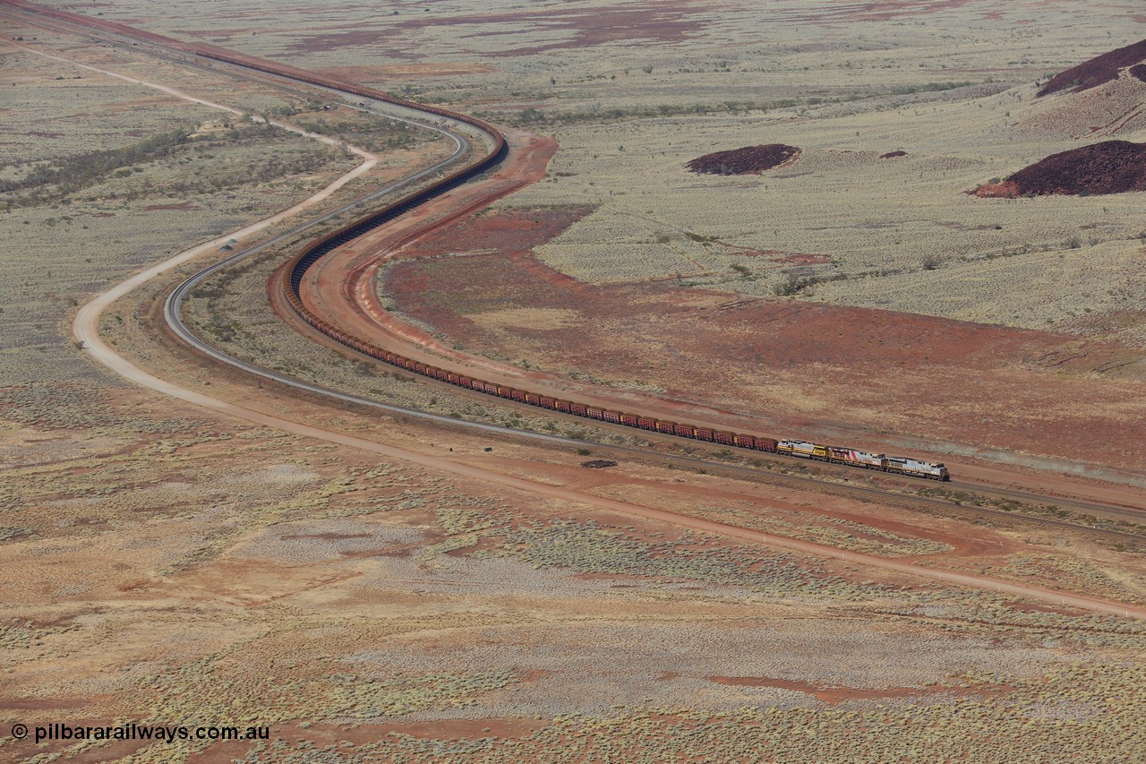 151111 9515
A loaded train behind General Electric ES44DCi units 8113 serial 59105 in the original silver livery and 8145 serial 58726 in the tiger strip Rio livery and Dash 9-44CW 9433 serial 54766 in ROBE Pilbara Iron livery runs along on the West Mainline bound for Cape Lambert viewed from Table Hill.
Keywords: 8113;GE;ES44DCi;59105;