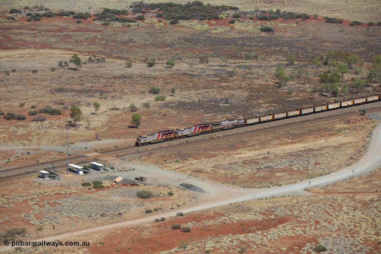 151111 9545
An empty train led by General Electric ES44DCi units 8162 serial 60226 and 8167 serial 60231 both in the Rio Tinto tiger strip livery leading Dash 9-44CW 7093 serial 47772, the last of the original build of Dash 9 units at the 52.9 km grade crossing.
Keywords: 8162;GE;ES44DCi;60226;